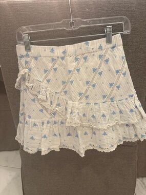 Love Shack Fancy White Ruffled Mini Skirt with Blue Floral Print
